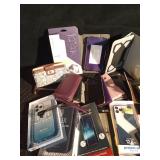 Lot of phone cases including an Otter and tablet covers