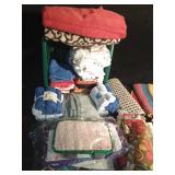 Laundry basket of kitchen towels and dish cloths, wash cloths, rugs, table cloth and runner and floor scrubber pads, bathmat