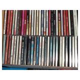 Lot of CDs and a visor cd holder and 1 cassette