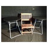 2 patio metal fold up tables and a child