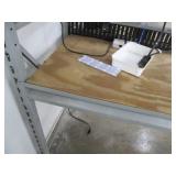 Shelf with some electronics and wiring, as pictured