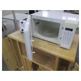 Nice wood kitchen cart with a microwave and toaster