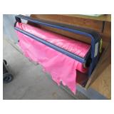 Roll dispenser with roll of plastic film