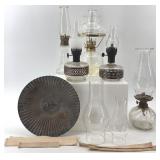 Collection of Vintage Oil Lamps with Glass Chimneys and Accessories