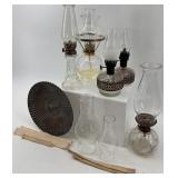 Collection of Vintage Oil Lamps with Glass Chimneys and Accessories