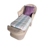 Wicker Chaise Lounge with Plaid Cushion and Purple Pillow