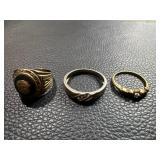 Three Rings Featuring a Class Ring, Band, and Gold-Tone Diamond-Style Ring