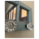 Decorative Wall Mirror with Glass Knob Hooks and Ornate Accent
