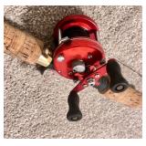 Vintage Fishing Rod with Red Baitcasting Reel and Cork Handle