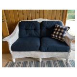 Wicker Loveseat with Navy Cushions and Plaid Pillow