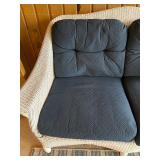 Wicker Loveseat with Navy Cushions and Plaid Pillow