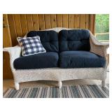 Wicker Loveseat with Navy Cushions and Plaid Pillow