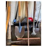 Collection of Garden Tools Including Shovels, Axe, Hoes, Brooms, and Pitchfork