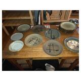 Collection of 13 Handmade Pottery Plates with Artistic Designs