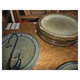Collection of 13 Handmade Pottery Plates with Artistic Designs