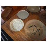 Collection of 13 Handmade Pottery Plates with Artistic Designs