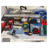 Collection of Measuring Tools, Clamps, and Hand Tools Including Tape Measures and Squares