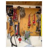 Workshop Hand Tool Collection with Levels, Pipe Wrenches, and Squares