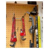Workshop Hand Tool Collection with Levels, Pipe Wrenches, and Squares