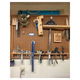 Assorted Hand Tools and Wrenches Hanging on Pegboard