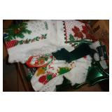 Box of christmas towels, hot pads, ribbon, cookie trays, tree bag, bell, candle holder, snowman Box of christmas towels, hot pads, ribbon, cookie trays, tree bag, bell, candle holder, snowman