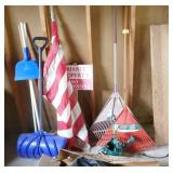 Wall of rakes, brooms, shovel, flag Wall of rakes, brooms, shovel, flag