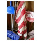 Wall of rakes, brooms, shovel, flag Wall of rakes, brooms, shovel, flag
