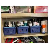 Collection of Spray Paint Cans, Polyurethane, and Adhesives in Storage Baskets