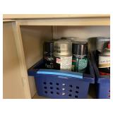 Collection of Spray Paint Cans, Polyurethane, and Adhesives in Storage Baskets