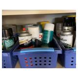 Collection of Spray Paint Cans, Polyurethane, and Adhesives in Storage Baskets