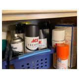 Collection of Spray Paint Cans, Polyurethane, and Adhesives in Storage Baskets