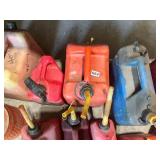 Collection of 14 Used Fuel Cans of Various Sizes and Colors