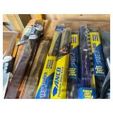 Assorted Automotive Parts Including Wiper Blades, Coupler, and Hubcaps