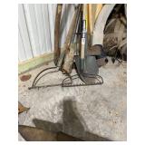 Collection of Assorted Garden Tools Including Rakes, Shovels, and Hoe