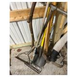 Collection of Assorted Garden Tools Including Rakes, Shovels, and Hoe