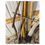 Collection of Assorted Garden Tools Including Rakes, Shovels, and Hoe