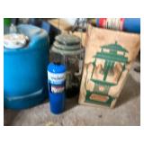 Vintage Coleman Lantern with Propane Tanks and Blue Water Jug