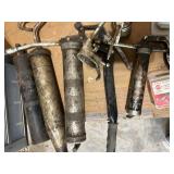 Assorted Grease Guns with Mixed Hardware and Fasteners