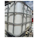 Stack of Used 275-Gallon IBC Tote Tanks with Metal Cages