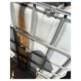Stack of Used 275-Gallon IBC Tote Tanks with Metal Cages