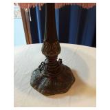 Vintage Table Lamp with an ornate base with intricate detailing and a fringed lampshade