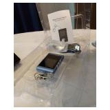 Assorted Electronics and Accessories including Flip Phones, Portable FM Scan Radio, TomTom GPS, and Digital Picture Viewer