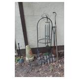 Wind chime, garden tools, and decorative items including a large vase and metal bicycle decoration