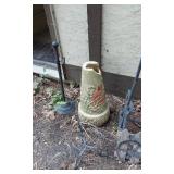 Wind chime, garden tools, and decorative items including a large vase and metal bicycle decoration