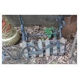 Wind chime, garden tools, and decorative items including a large vase and metal bicycle decoration