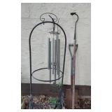 Wind chime, garden tools, and decorative items including a large vase and metal bicycle decoration