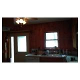 Cabin Teardown:   Kitchen Cabinets, Counter, Sink, Walls, Window, Stove, Ceiling Fan.