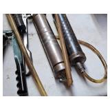 (4) Grease Guns and (1) Pump