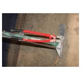 Group of Hand Tools Including Pickaxe, Bolt Cutters, and Post Driver