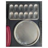Collection of Bakeware Trays, Cooling Racks, Madeleine Pans, and Pizza Tray Collection of Bakeware Trays, Cooling Racks, Madeleine Pans, and Pizza Tray
